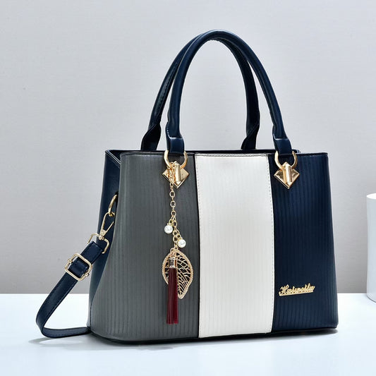 Color-blocked women's handbag, trendy and fashionable, made of PU material, suitable for shoulder or crossbody use, large capacity.