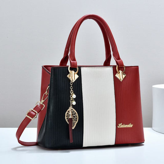 Color-blocked women's handbag, trendy and fashionable, made of PU material, suitable for shoulder or crossbody use, large capacity.